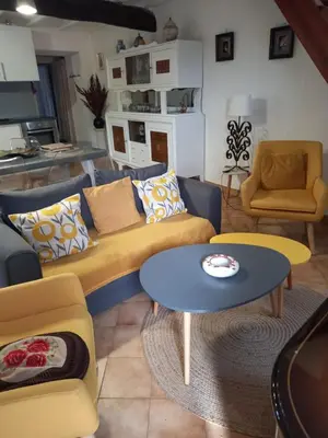 a living room with couches and a table and chairs at Appartement Casa Rose in Sollacaro