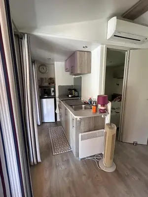 a small kitchen with a sink and a counter at Mobil-Home U Forconu in Pianottoli-Caldarello