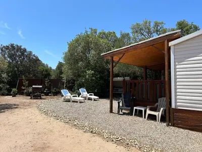 a group of chairs sitting under a pavilion at Mobil-Home U Forconu in Pianottoli-Caldarello