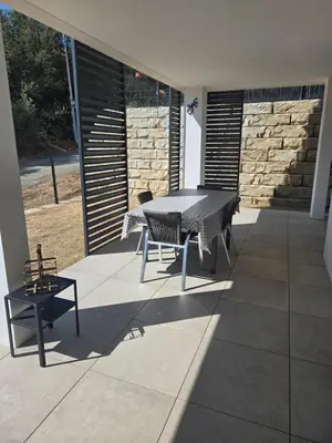 a patio with a table and chairs on a patio at Chez Corinne et Paul classé 3 Etoiles in Propriano
