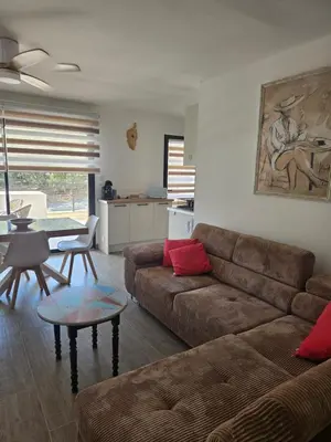 a living room with a couch and a table at Chez Corinne et Paul classé 3 Etoiles in Propriano