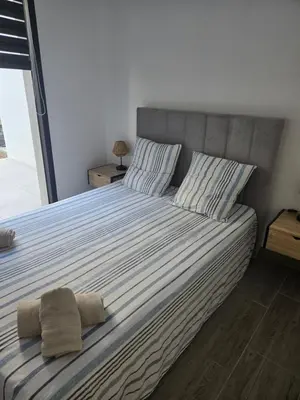 a bedroom with a bed with two towels on it at Chez Corinne et Paul classé 3 Etoiles in Propriano