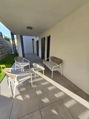 two chairs and a table on a patio at Chez Corinne et Paul classé 3 Etoiles in Propriano