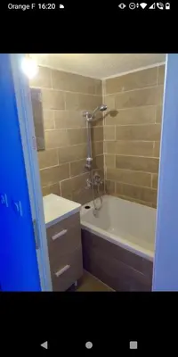 a bathroom with a shower and a tub and a sink at Bas de villa à 100 M de la plage in Solaro