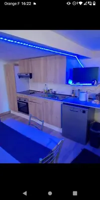 a kitchen with a blue light in a room at Bas de villa à 100 M de la plage in Solaro