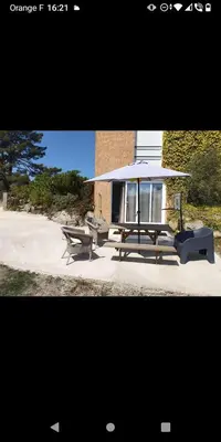 a gazebo with two benches and a picnic table at Bas de villa à 100 M de la plage in Solaro
