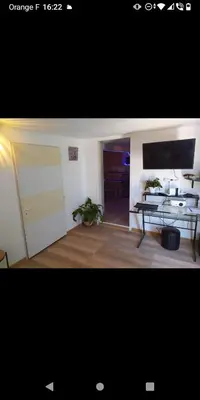 a living room with a table and a television at Bas de villa à 100 M de la plage in Solaro