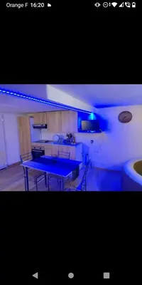 a kitchen with a blue table in a room at Bas de villa à 100 M de la plage in Solaro