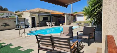 a patio with chairs and a swimming pool at Bed and kitchen with pool in Aléria