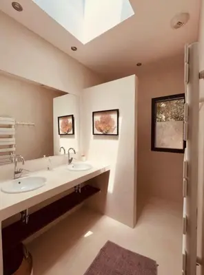 a bathroom with two sinks and a skylight at Peaceful Villa Between Sea And Mountain In Corsica in Lecci