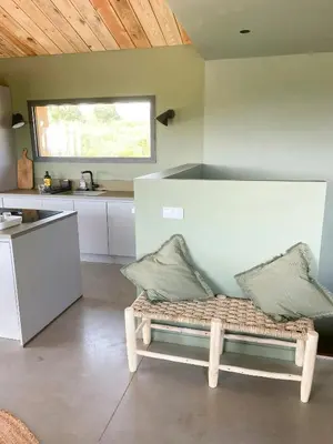 a kitchen and dining room with a table and chairs at Modern Villa With Sea View In Corsica in Pianottoli-Caldarello