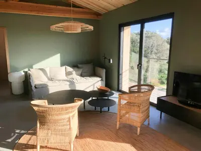 a kitchen with a bench with two pillows on it at Modern Villa With Sea View In Corsica in Pianottoli-Caldarello