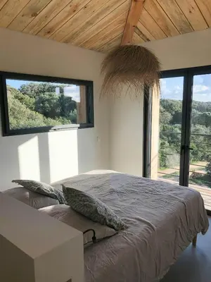 a living room with a couch and a table and chairs at Modern Villa With Sea View In Corsica in Pianottoli-Caldarello
