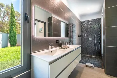 a bathroom with a sink and a shower at La Villa Grazzoso - Piscine Privée in Sainte-Lucie de Porto-Vecchio