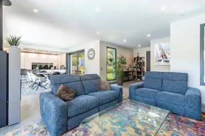 a living room with two blue chairs and a couch at La Villa Grazzoso - Piscine Privée in Sainte-Lucie de Porto-Vecchio