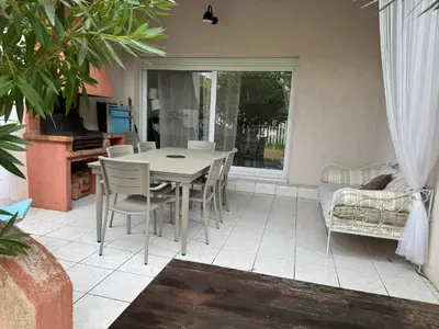 a dining room table and chairs in a room at Mini villa Corse du sud Residence U Re D Alzetu in Lecci