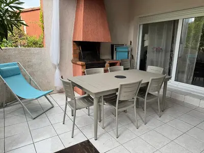 a table and chairs on a patio with a piano at Mini villa Corse du sud Residence U Re D Alzetu in Lecci
