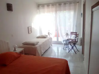 a bedroom with two beds and a window at Mini villa Corse du sud Residence U Re D Alzetu in Lecci