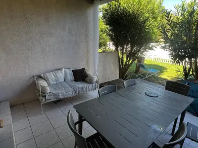 a table and chairs and a couch on a patio at Mini villa Corse du sud Residence U Re D Alzetu in Lecci