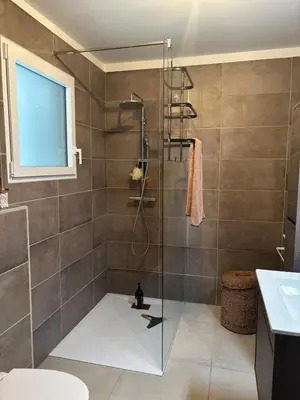 a shower with a glass door in a bathroom at Appartement neuf Porticcio in Porticcio