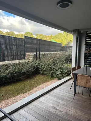 a patio with a table and chairs and a fence at Appartement neuf Porticcio in Porticcio