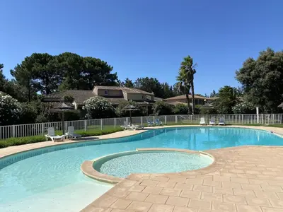 a large swimming pool with chairs and a fence at Saint Cyprien, Corse du Sud - Mini Villa - 6 couchages in Lecci