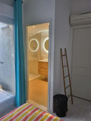 a bathroom with a glass shower with a sink at Saint Cyprien, Corse du Sud - Mini Villa - 6 couchages in Lecci