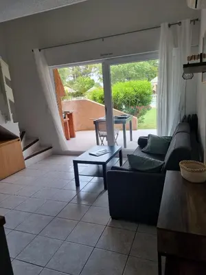 a living room with a couch and a table at Saint Cyprien, Corse du Sud - Mini Villa - 6 couchages in Lecci