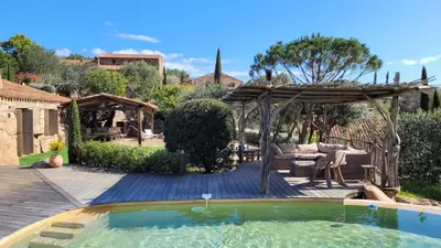 a backyard with a pool and a pergola at Casa di Sognu in Porto-Vecchio
