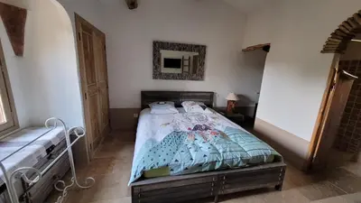 a bedroom with a bed and a mirror on the wall at Casa di Sognu in Porto-Vecchio