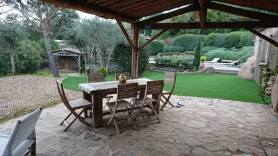 a table and chairs under a pavilion in a garden at Casa di Sognu in Porto-Vecchio