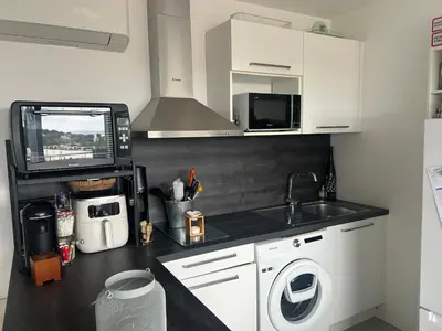 a kitchen with a sink and a washing machine at Porticcio in Grosseto-Prugna