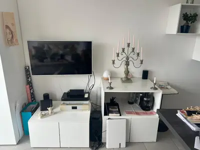 a living room with white furniture and a tv at Porticcio in Grosseto-Prugna