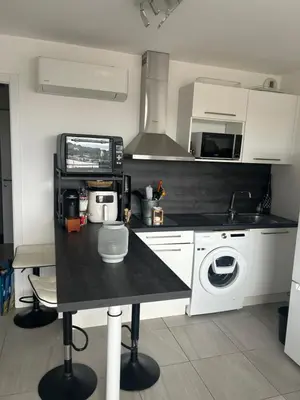 a kitchen with a black counter top in a kitchen at Porticcio in Grosseto-Prugna