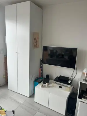 a living room with a tv and a white cabinet at Porticcio in Grosseto-Prugna