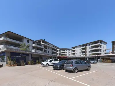 two cars parked in a parking lot in front of buildings at Apartment La vallée by Interhome in Aléria