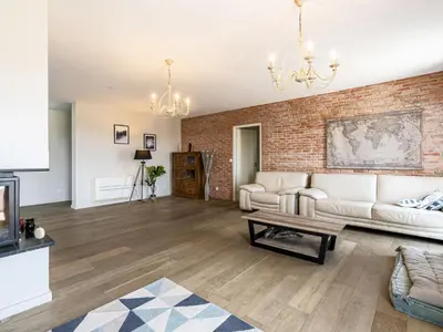a living room with a couch and a brick wall at Apartment La vallée by Interhome in Aléria