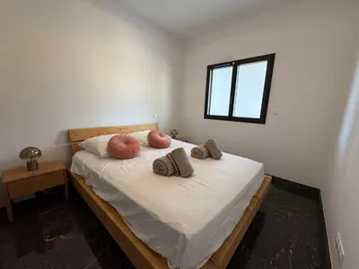 a bedroom with a bed with two pillows on it at La Petite Civita de Piétrosella in Pietrosella