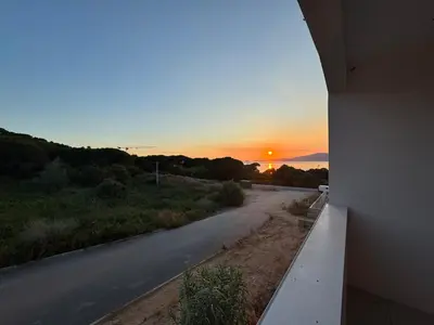 an empty road with the sunset in the background at La Petite Civita de Piétrosella in Pietrosella