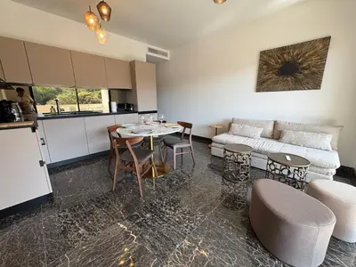 a living room with a couch and a table and chairs at La Petite Civita de Piétrosella in Pietrosella