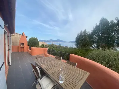 a patio with a table and chairs on a balcony at Porticcio, Villa Terra di Sole in Grosseto-Prugna