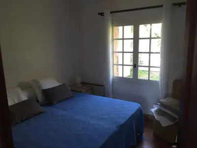 a bedroom with a blue bed and a window at Porticcio, Villa Terra di Sole in Grosseto-Prugna