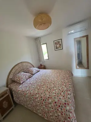 a bedroom with a bed and a mirror in it at Cocon chaleureux bord de plage vue sanguinaire in Ajaccio