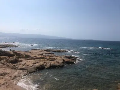 a view of the ocean with rocks in the water at Cocon chaleureux bord de plage vue sanguinaire in Ajaccio