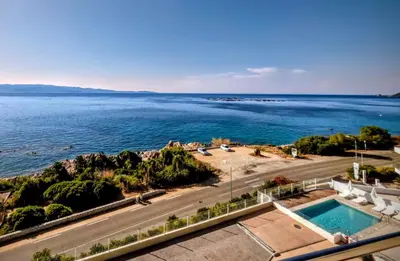 a view of the ocean from a building at Cocon chaleureux bord de plage vue sanguinaire in Ajaccio