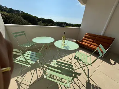 a balcony with a table and chairs and a bottle of wine at La bella Vista di Civita de Pietrosella in Pietrosella