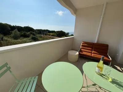 a balcony with a table and chairs and a bottle of wine at La bella Vista di Civita de Pietrosella in Pietrosella