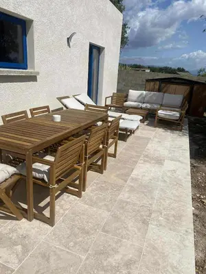 a wooden table and chairs on a patio at U Mandriolu in Prunelli-di-Fiumorbo