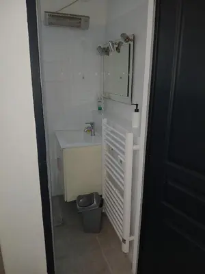a bathroom with a sink and a toilet and a mirror at Chambre avec SDB WC à 100 m du départ du GR20 in Calenzana