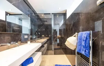 a bathroom with three sinks and a shower at Villa Bianca in Zonza